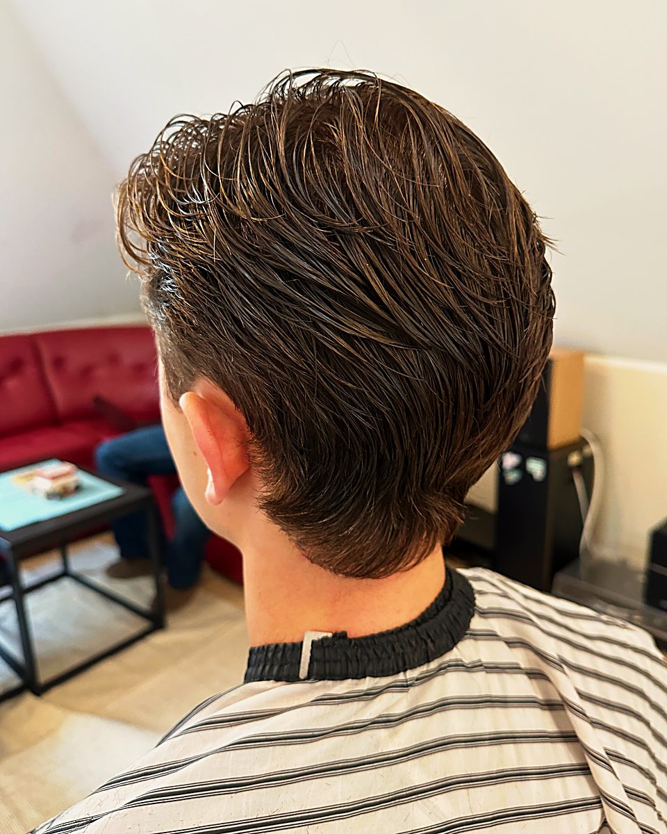 Swept-back cut with a tapered nape from behind